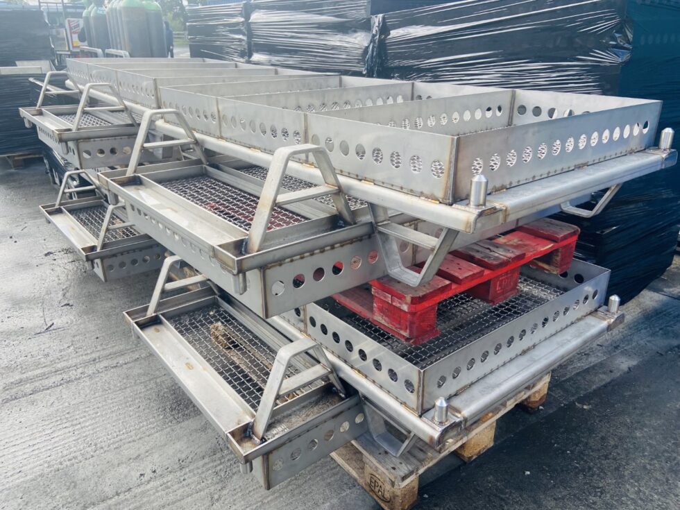 Skid base for IV bottle sterilization trays